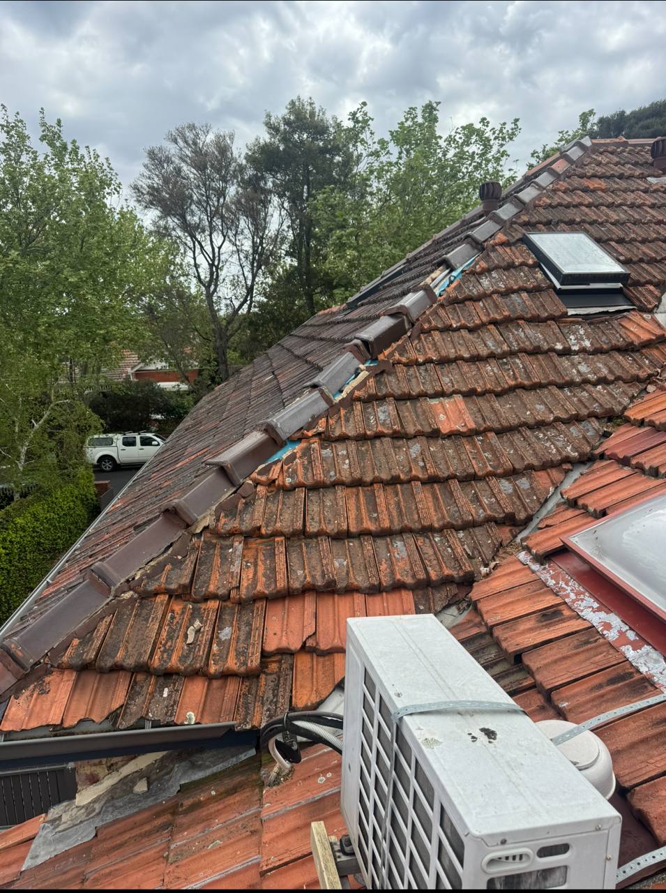 Before: Storm damaged terracotta roof with broken ridge capping